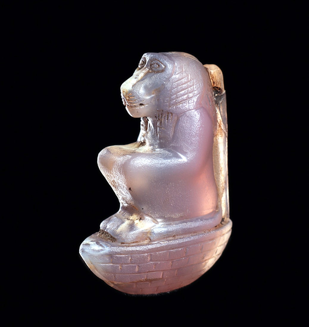 Egyptian Amethyst Baboon Amulet: Fine carved amethyst stone amulet, depicting a baboon sitting on top of a small boat, integral support column on his back, having a drilled suspension hole at the top of the column. Beautifully incise