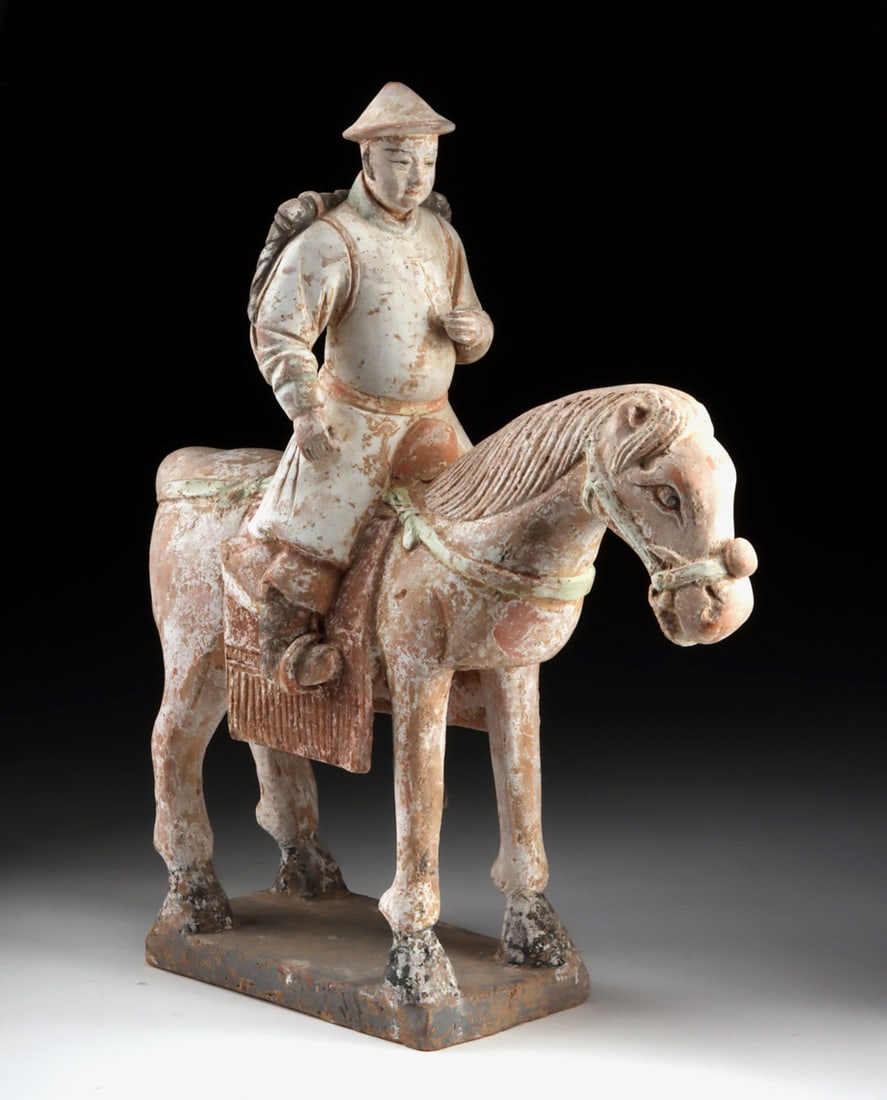 Ming Dynasty Tomb Companion - Horse and Traveling Rider: East Asia, China. Ming Dynasty, ca. 1368-1644 CE. A Ming Dynasty pottery horse and rider presented with a calm, grounded presence, the pair standing squarely upon a rectangular base as if awaiting dep