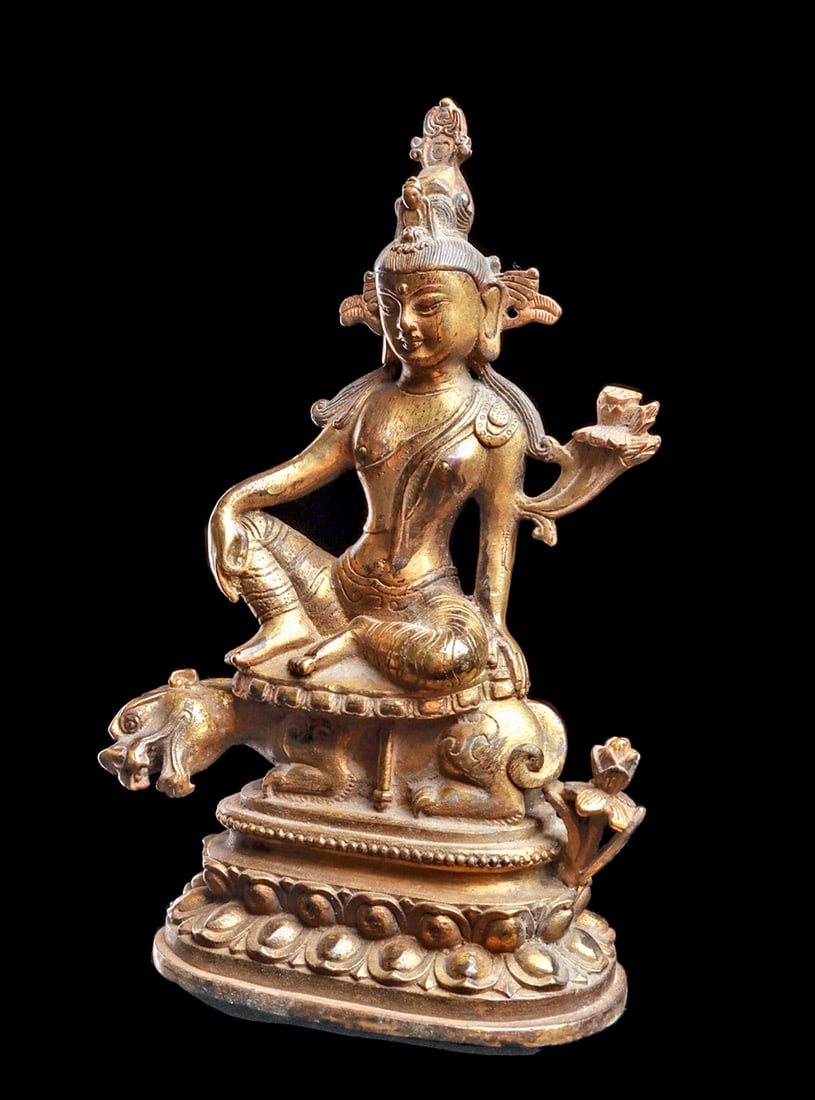 Tibetan Drolma Karmo / White Tara Deity: Fine cast copper/bronze alloy depicting Tara seated on top of a crouching feline on a lotus blossom base, having a copper base plate. A lotus flower sprouts from the base behind the feline, and anothe