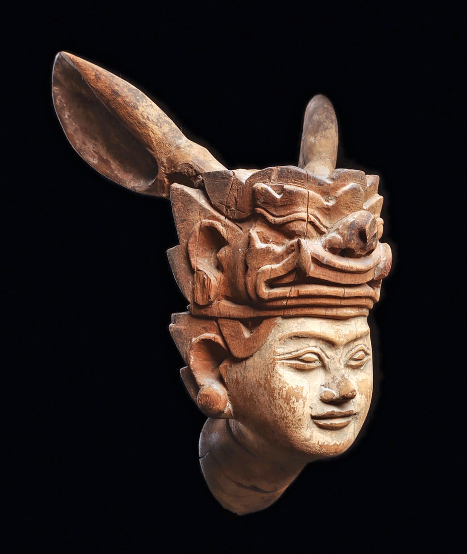 Burmese Nat Man Spirit Mask: Carved wooden Nat spirit guardian head to be hung for protection in the entrance of a chief's abode. Head juts forward, and is carved with a commanding visage, serving as an apotropaic presence. Crown