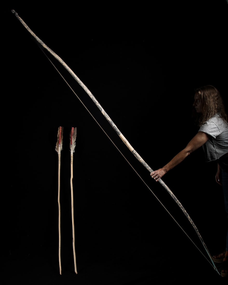 Huge San Felipe Painted Dance Bow & 2 Feathered Arrows: Native American, Southwest, New Mexico, San Felipe Pueblo, ca. 1930s to 1940s CE. A monumental San Felipe Pueblo dance bow with two matching arrows, each a testament to the ceremonial artistry and cul