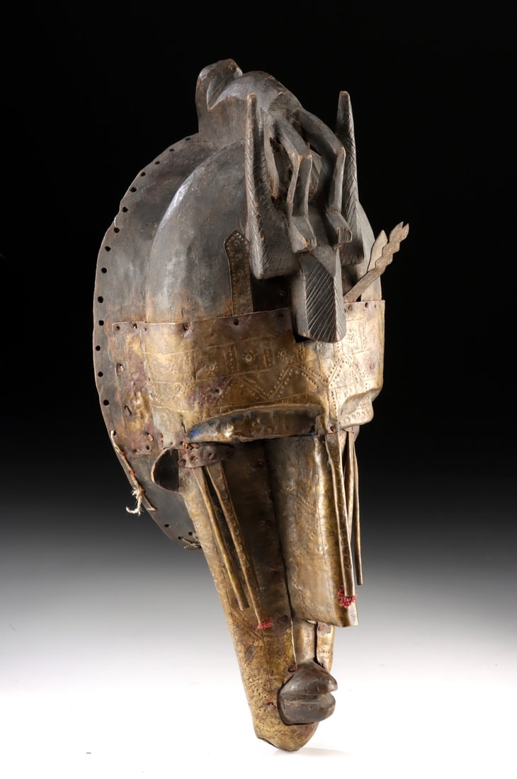 Early 20th C. Mali Marka Kore Mask Wood / Brass Overlay: West Africa, Mali, Marka, ca. early 20th century CE. A striking early 20th century Marka kore mask, masterfully carved from wood and sheathed in finely tooled brass, its lustrous metal surface meticul