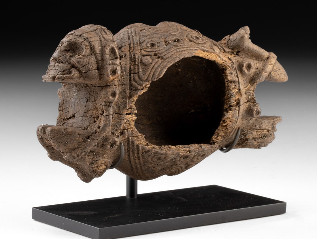 Taino Wooden Bowl with Zemi Figural Handles: Pre-Columbian, Caribbean, Taino culture, ca. 1000 to 1500 CE. A powerful ritual vessel carved from a single block of hardwood, this Taino bowl takes the extraordinary form of two intertwined zemi figu