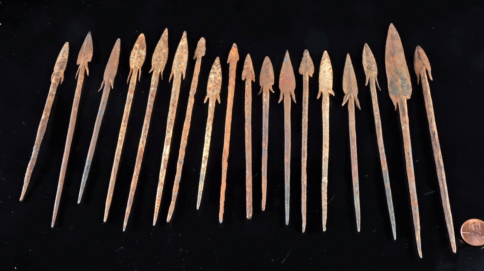 18 Assorted African Nigerian Iron Hunting Spear Heads: West Africa, Nigeria, ca. 19th to early 20th century CE. A collection of 18 iron arrow or spear heads with the remains of long tang necks for hafting to a wood shaft, and barbed shoulders, with slende