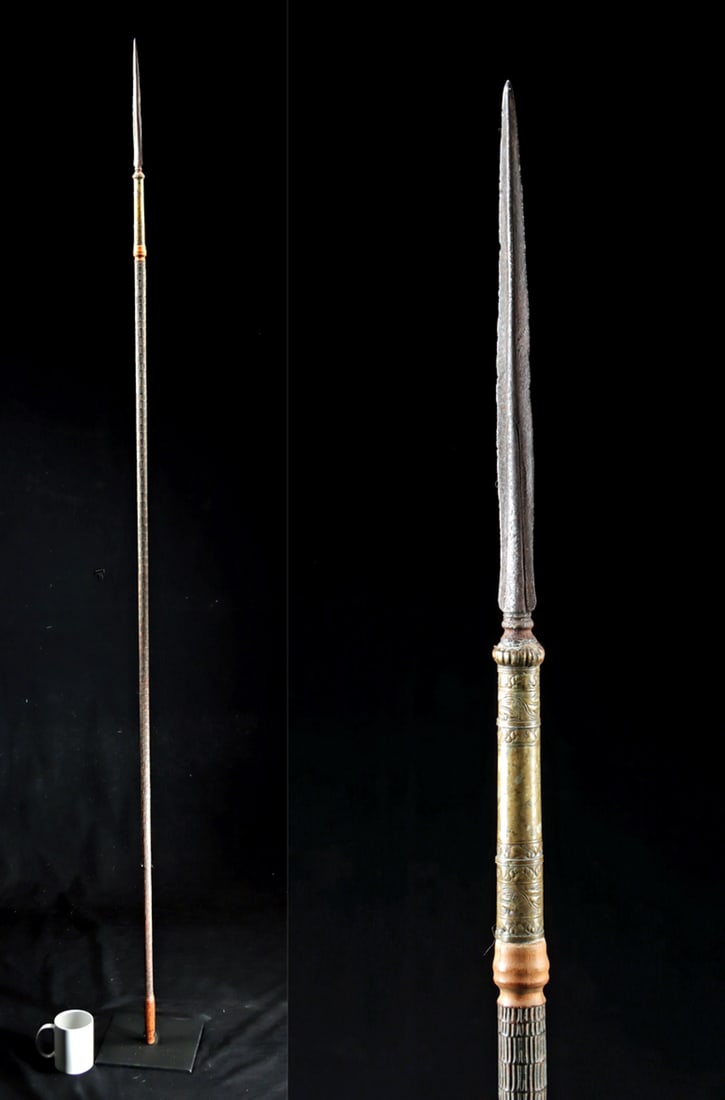 19th C. Javanese Polearm Spear with Carved Wood Shaft: Southeast Asia, Indonesia, Java, ca. 19th century CE or earlier. A slender spear with a narrow steel blade and an ornate nickel-brass collar worked in repousse and etched with scrolling foliate motifs