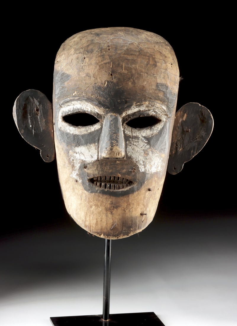 Large Borneo Iban Dayak Wooden Tribal Mask: Southeast Asia, Indonesia, Borneo, Sarawak, Iban Dayak peoples, ca. early to mid-20th century CE. A large wooden anthropomorphic mask carved from a single block of lightweight wood. The visage feature
