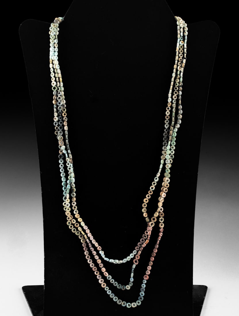 Ancient Egyptian Faience Discoidal Bead Necklace: Egypt, New Kingdom to Late Period, ca. 1550 to 332 BCE. A three-strand necklace composed of ancient faience discoidal beads restrung in modern times as a wearable piece. The small ring-shaped beads