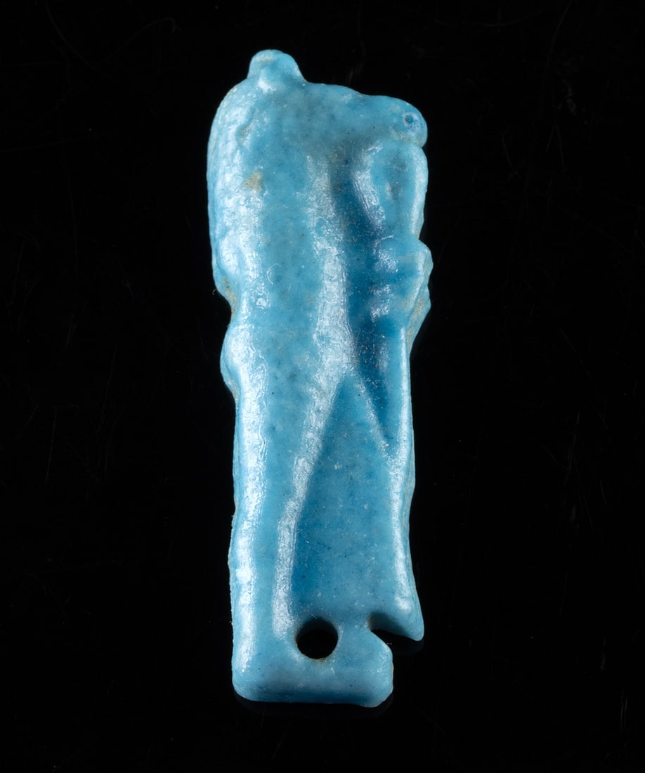 Egyptian Faience Amulet of Duamutef - Son of Horus: Egypt, Late Dynastic to Ptolemaic period, ca. 664 to 30 BCE. A vivid blue guardian of the afterlife, this faience amulet depicts Duamutef, the jackal-headed son of Horus, rendered mummiform in