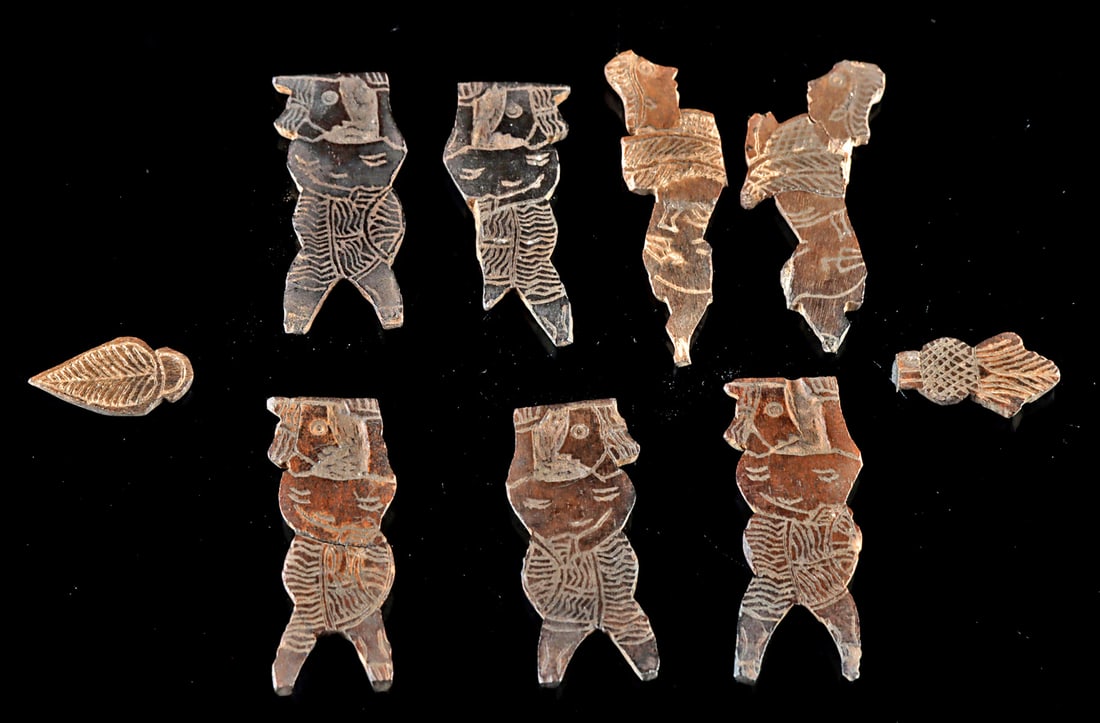 9 Ancient Mesopotamian Bone Inlays w/ Sphinxes: Near East, Mesopotamia / Assyria & Egypt, ca. 1000 BCE to 100 CE. A collection of nine bone and ivory plaques, each intricately etched on one side with designs including five human figures in profile,