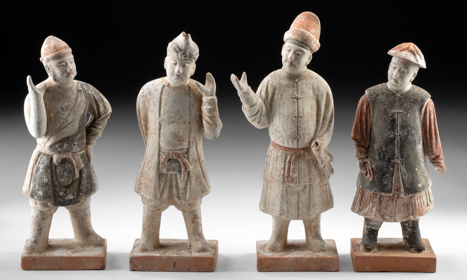 Ming Dynasty Pottery Tomb Attendants - Set of 4: East Asia, China, Ming Dynasty, ca. 1368 to 1644 CE. A dignified quartet of Ming Dynasty tomb attendants stands in quiet procession, each figure animated by subtle gesture and individualized expressio