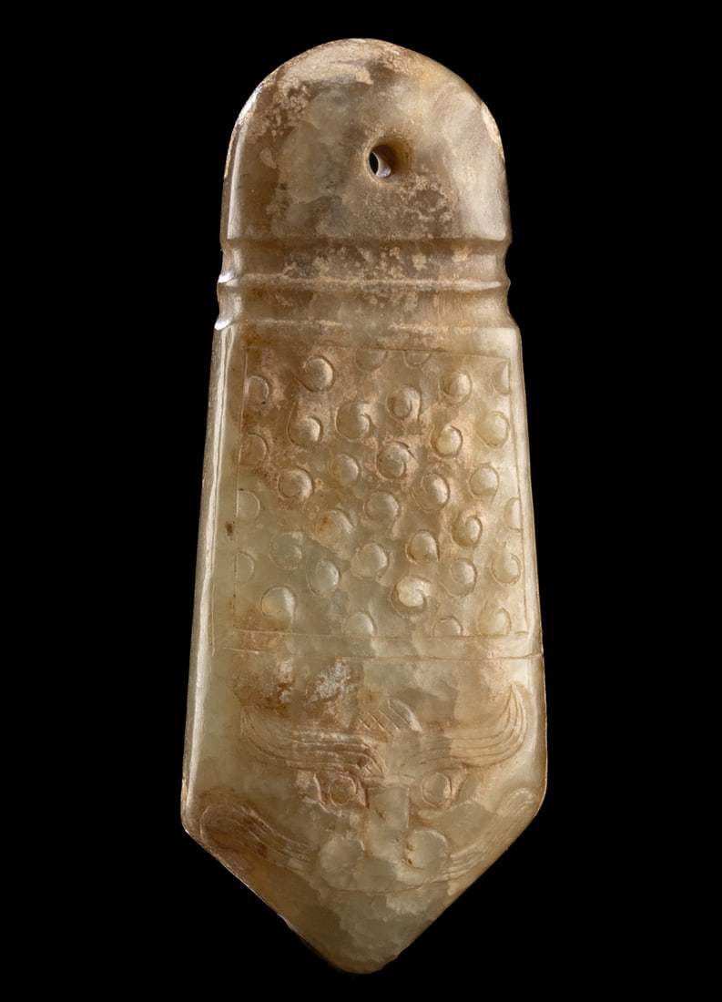 Chinese Jade Pendant Plaque with Taotie Face: East Asia, China, ca. 20th century CE. A nephrite jade pendant carved in the form of a pointed plaque, with a rounded top pierced for suspension. The surface is adorned with raised spiral and dot moti