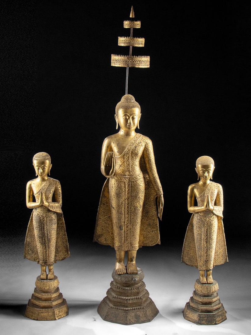 Rattanakosin Triad Buddha and Monks Divine Parasol: Southeast Asia, Thailand, Rattanakosin period, ca. 19th to early 20th century CE. A remarkable group of three statues featuring a central Buddha figure shaded by an umbrella, and accompanied by two mo