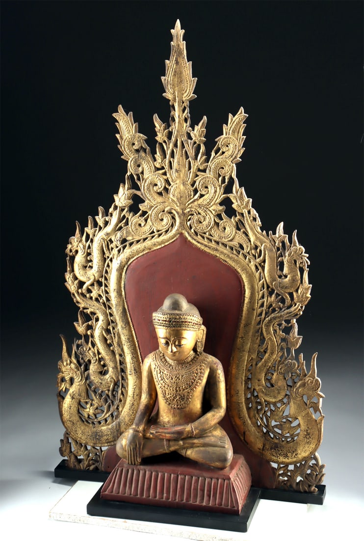 Burmese Enthroned Jambupati Buddha Naga Back Panel: Southeast Asia, Burma (Myanmar), ca. late 19th to early 20th century CE. A stunning wooden Buddha statue, lacquered and gilded, seated in dhyanasana on a rectangular pedestal with a massive, intricate