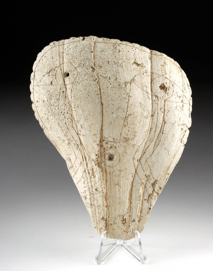 13th C. Mississippian Shell Mask: Native American, Southeastern United States, Mississippian culture, ca. 13th to 14th century CE. A powerful and rare expression of Mississippian ritual artistry, this carved marine shell mask embodies