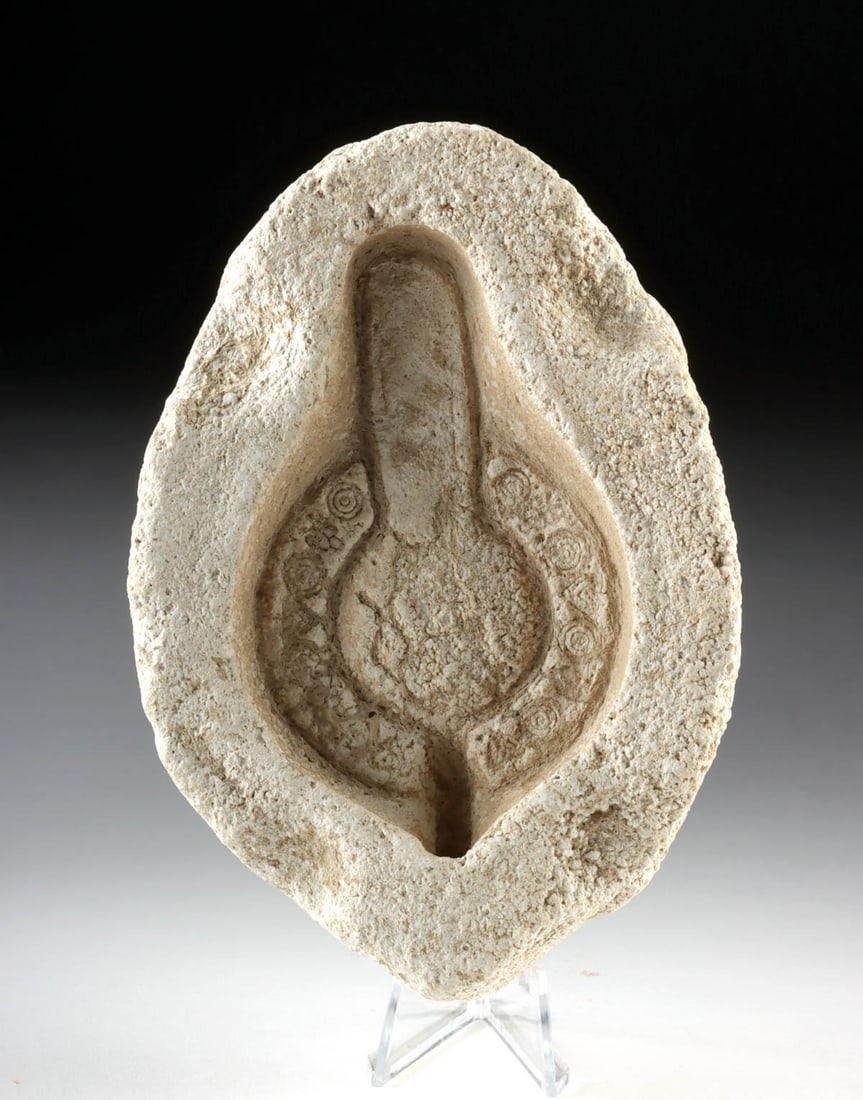 Late Roman Gypsum Oil Lamp Mold: Late Roman to early Byzantine, ca. 3rd to 6th century CE. A compelling artifact of ancient industry, this gypsum oil lamp mold preserves the negative impression of a finely decorated lamp once cast wi