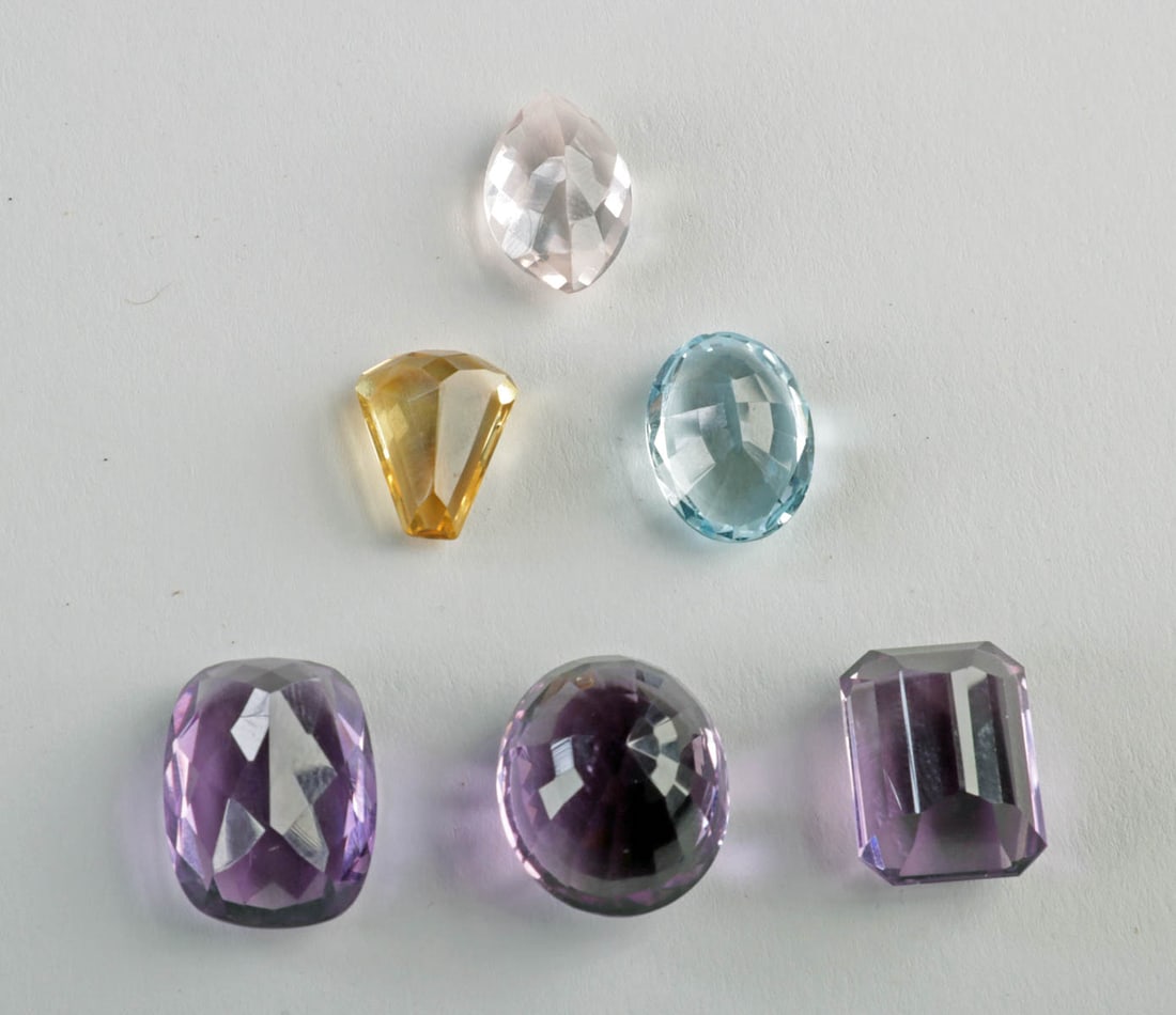 Topaz, Citrine & Amethyst: 6 Faceted Loose Gemstones: United States & South America, Brazil, ca. late 20th to early 21st century CE. A collection of seven faceted gemstones comprising Swiss blue topaz, citrine, three amethysts, and a pale pink quartz. Th