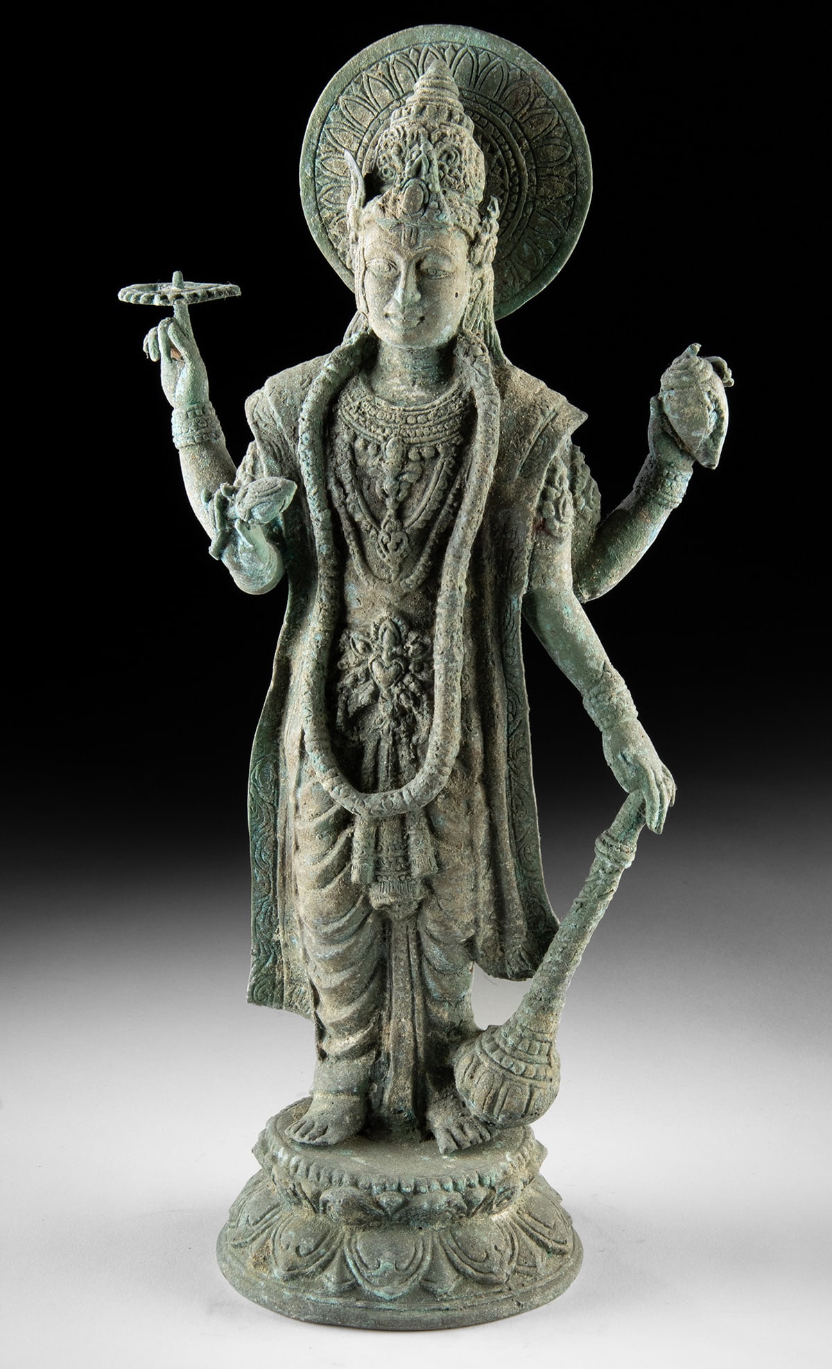 Indonesian Rustic Brass Standing Vishnu Statue: Southeast Asia, Indonesia, ca. mid-20th century CE. This brass standing Vishnu figure would add a serene, devotional accent to a garden, patio, or entryway, with a soft verdigris tone that blends nice