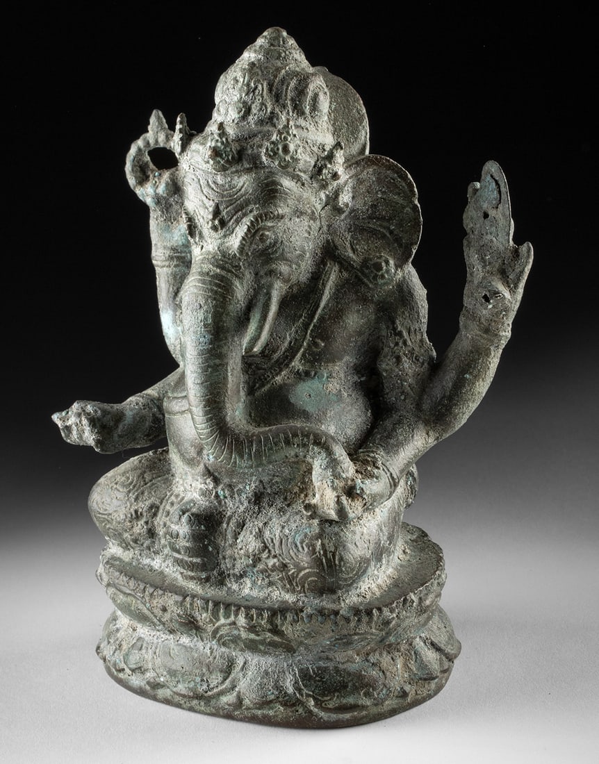 19th C. Javanese Brass Seated Ganesh on Double Lotus: Southeast Asia, Indonesia, Java, ca. 19th to 20th century CE. A finely cast Javanese brass figure of Ganesh, seated in calm authority upon a double lotus throne. The elephant-headed deity appears with