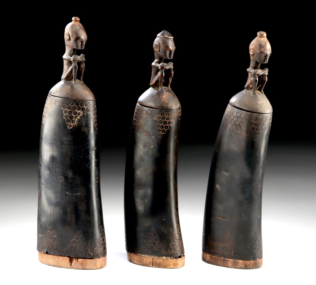 Three Toba Batak Medicine Horns w/ Figural Stoppers: Southeast Asia, Sumatra, Toba Batak culture, ca. early to mid-20th century CE. A sculptural and culturally resonant group of three Toba Batak medicine horns, carved from water buffalo horn and fitted