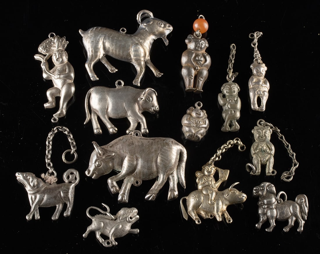 Chinese & Mongolian Silver Charms of Figures + Animals: East Asia, Northern China / Mongolia, ca. late 19th to mid-20th century CE. A collection of 13 silver and nickel brass charms depicting auspicious human figures and animals rendered in a lively folk s