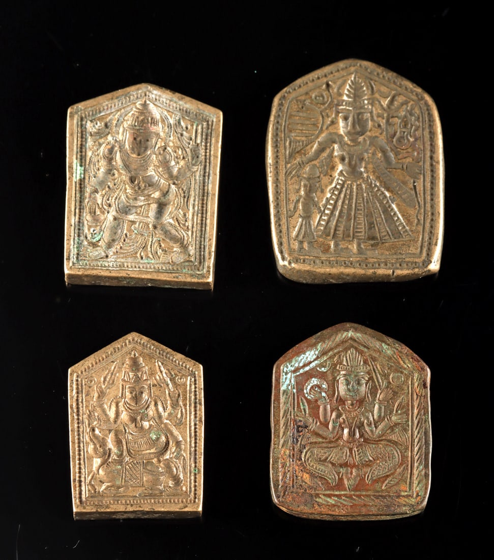 Four Indian Hindu Jewelry Pendant Molds of Deities: South Asia, India, ca. 18th to early 20th century CE. A group of four bronze jeweler's die molds, each cast with an image of a Hindu deity for producing small devotional ornaments or pendants. The sma