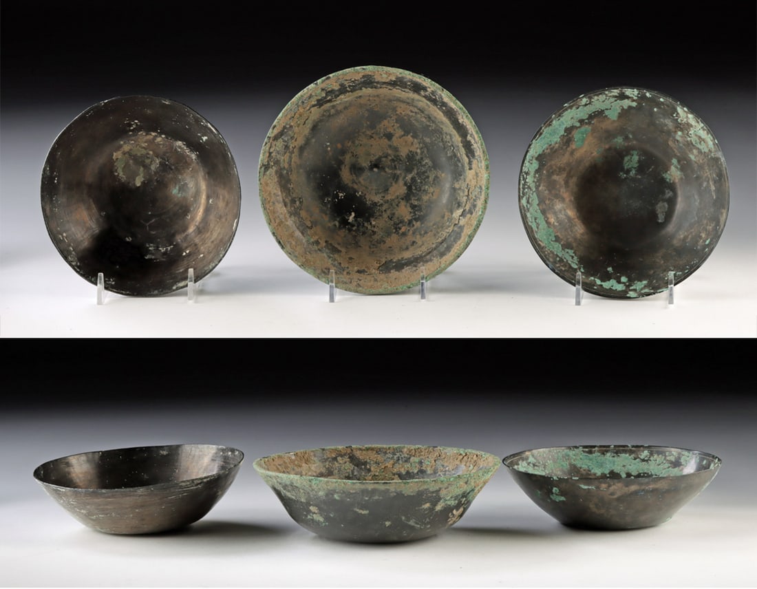 Sasanian Bronze Bowls - Set of Three: Ancient Near East, Persian Empire, Sasanian period, ca. 224 to 651 CE. A handsome group of three hammered bronze bowls displaying the simple yet refined forms characteristic of Sasanian metalwork. Eac