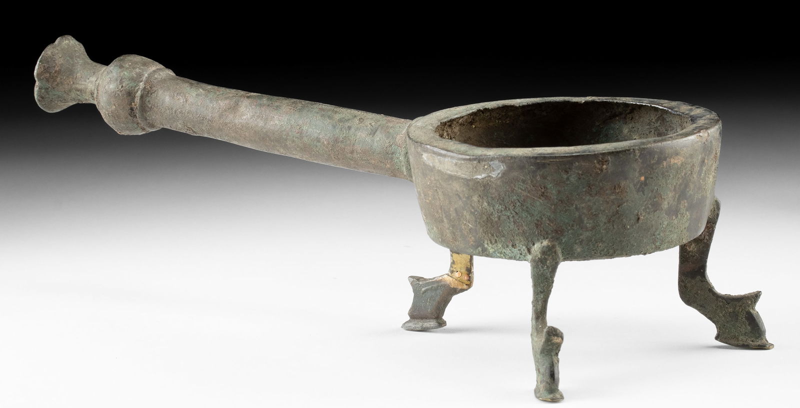 11th C. Islamic Khorasan Bronze Tripod Incense Burner: Central Asia, Iran, Khorasan region, Islamic period, ca. 11th to 12th century CE. A leaded bronze tripod incense burner formed with a shallow circular bowl supported by three bent, stylized legs and f