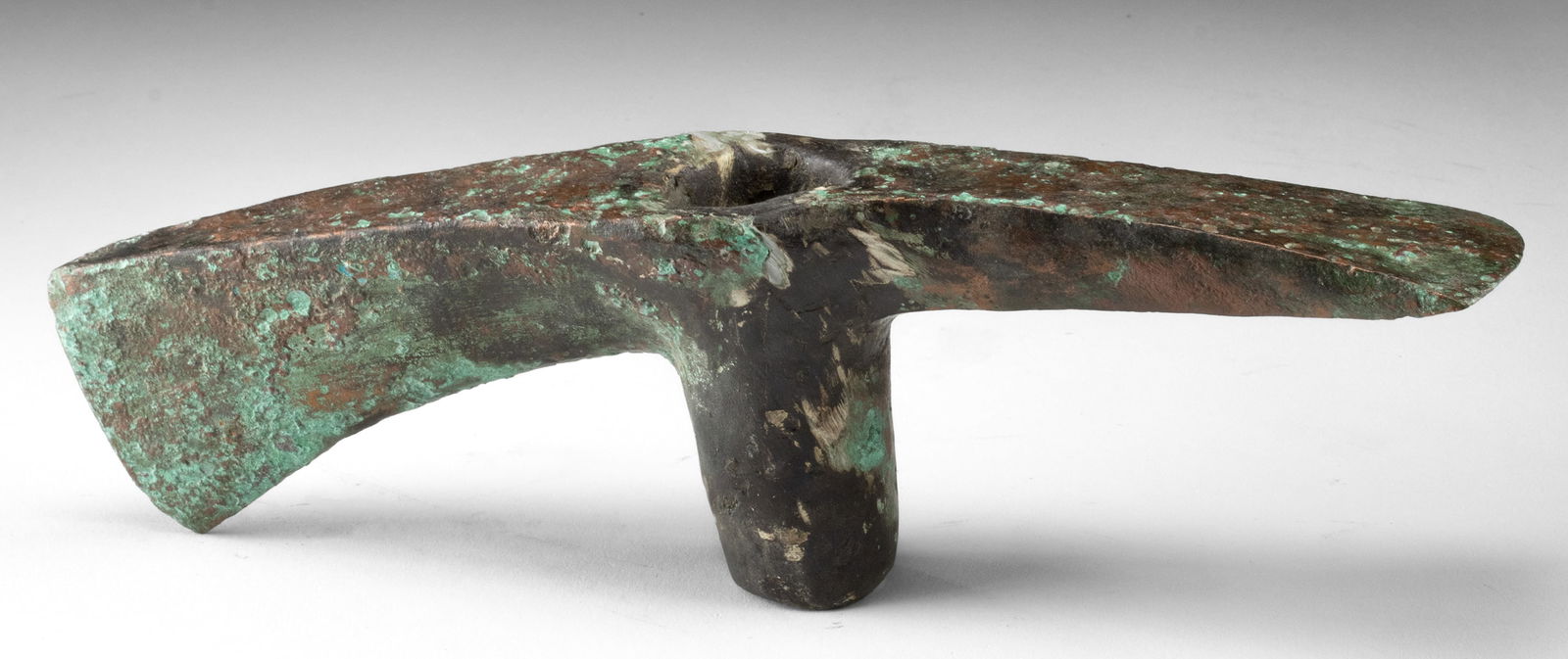 Luristan Copper Axe / Adze Head - Early Iron Age Tool: Central Asia, northwestern Iran to eastern Turkey, Luristan culture, ca. 1000 to 800 BCE. A cast copper adze/axe head with a broad, slightly arched blade and a central cylindrical hafting socket, the