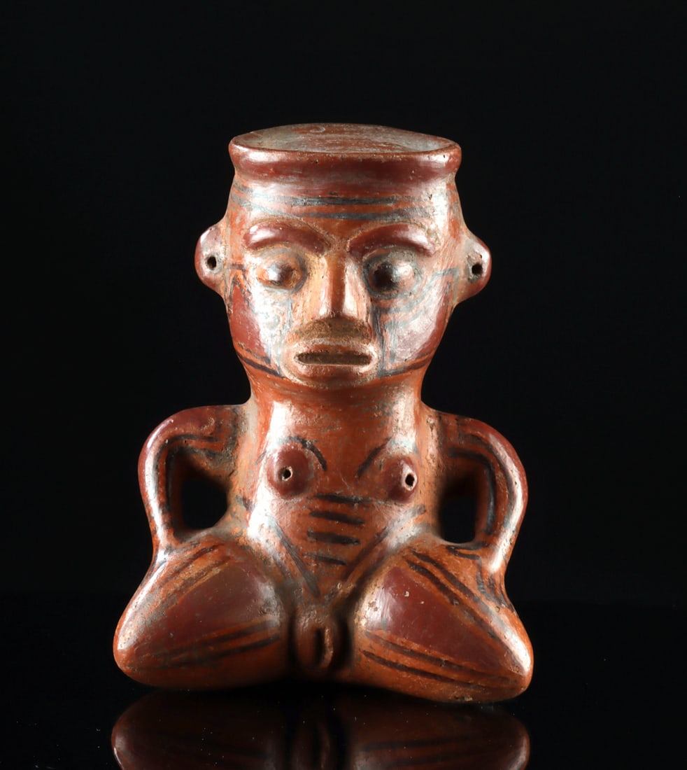 Costa Rican Nicoya Pottery Seated Nude Female Figure: Pre-Columbian, Central America, Costa Rica, Nicoya region, ca. 800 to 1200 CE. A finely modeled Nicoya pottery figure depicting a seated nude female with legs drawn upward and arms resting at the