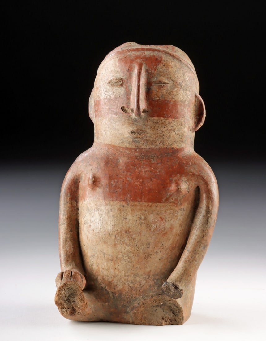 Quimbaya Pottery Figure Vessel: Pre-Columbian, Colombia, Quimbaya culture, ca. 9th to 14th century CE. A finely modeled Quimbaya pottery figure that merges human representation with utilitarian function, this seated effigy features