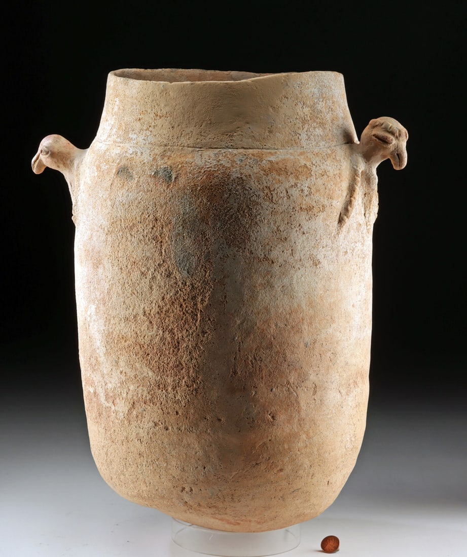 Large Colombian Moskito Funerary Urn with Bird Handles: Pre-Columbian, Colombia, Lower Magdalena River Region, Moskito culture, ca. 1000 to 1500 CE. A large funerary urn with an ovoid body tapering to a rounded base and a wide neck, fitted at the