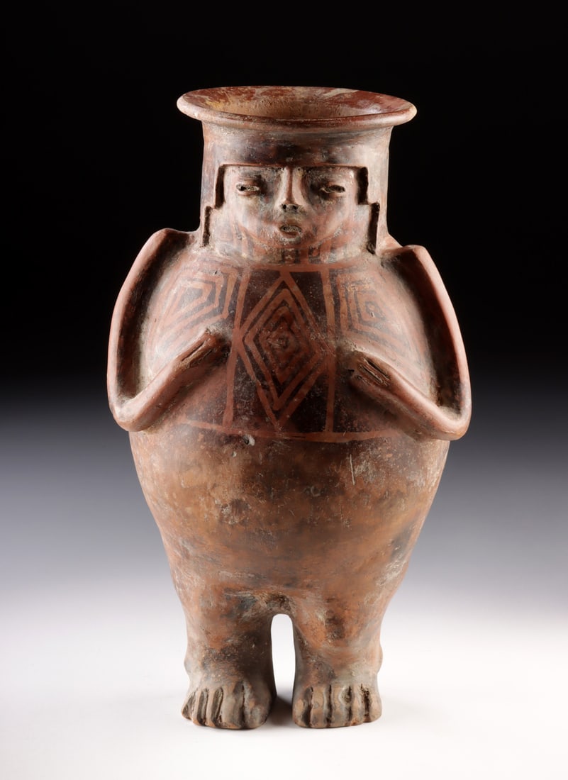 Rare Narino Anthropomorphic Pottery Jar - Standing Male: Pre-Columbian, Colombia, Narino culture, ca. 9th to 15th century CE. A striking Narino pottery male figural vessel depicted standing upright with both hands placed across the chest, this piece combine
