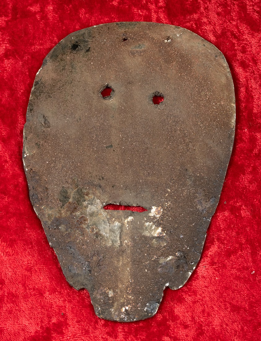 Exceptionally Rare Ancient Hopewell Mica Sheet Mask: Native American, Midwestern United States, Ohio, Ross County, Hopewell culture, ca. 200 BCE to 500 CE. An exceptionally rare mica sheet carved into a stylized human face mask. The form is flat and thi