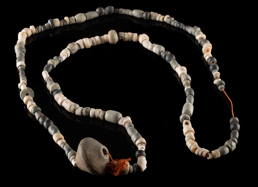 Anasazi Stone + Shell Beads & Pottery Spindle Whorl: Native American, Southwestern United States, Ancestral Puebloan (Anasazi), ca. 1000 to 1300 CE. A strand composed of assorted stone and shell beads strung on a cotton thread, centered by a pierced pot
