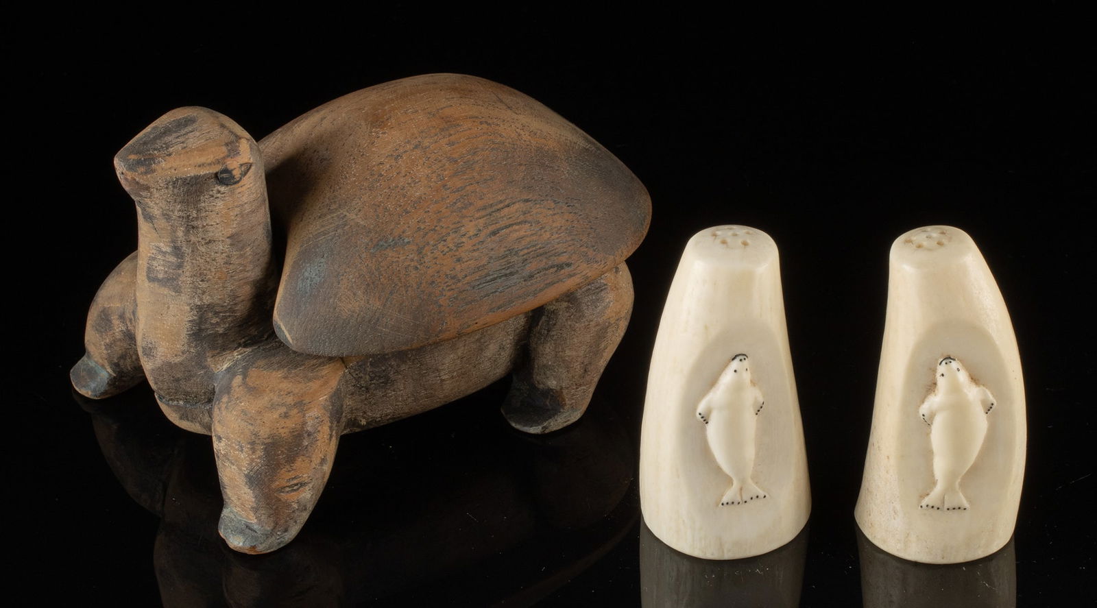Inuit Whale Ivory Salt Shakers & Wood Turtle Box: Native American, Northwestern United States, Alaska, Inuit, ca. mid-20th century CE. A matched set of salt and pepper shakers carved from sperm whale tooth, each decorated with a low-relief seal motif