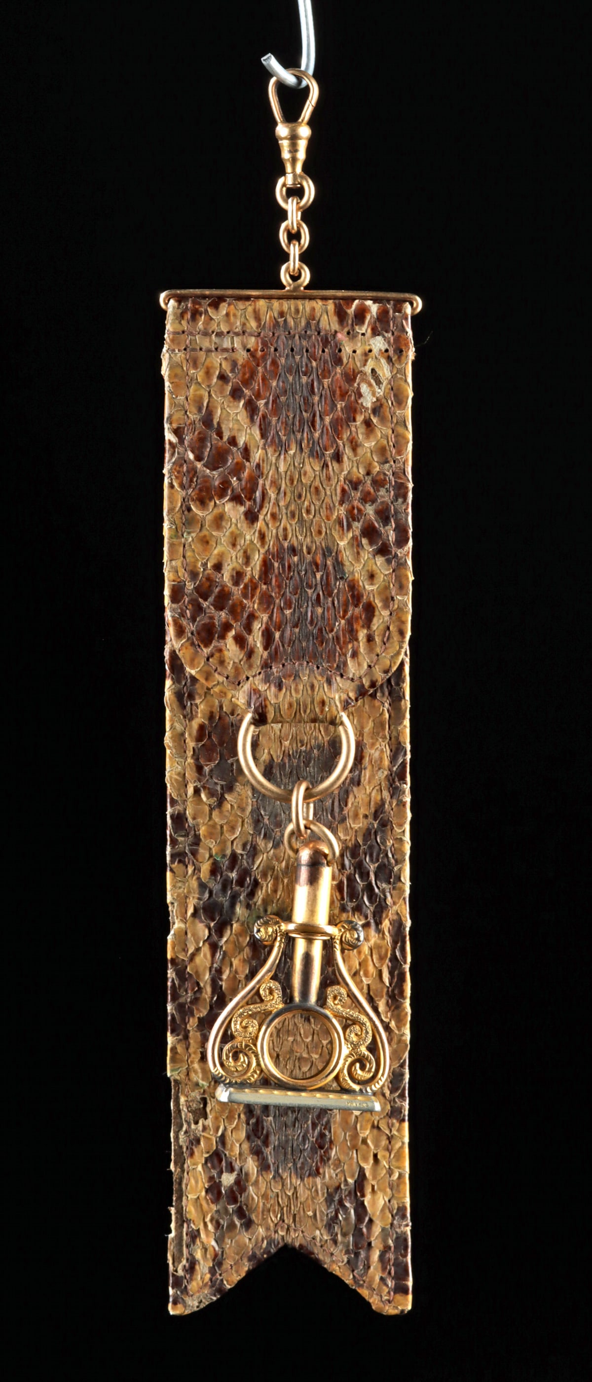 19th C. Gold Watch Fob on Rattlesnake Skin Strap: United States, ca. 19th to early 20th century CE. This unusual watch fob pairs a gold swivel clasp and decorative gold seal mount with a stitched rattlesnake-skin strap, likely assembled from earlier