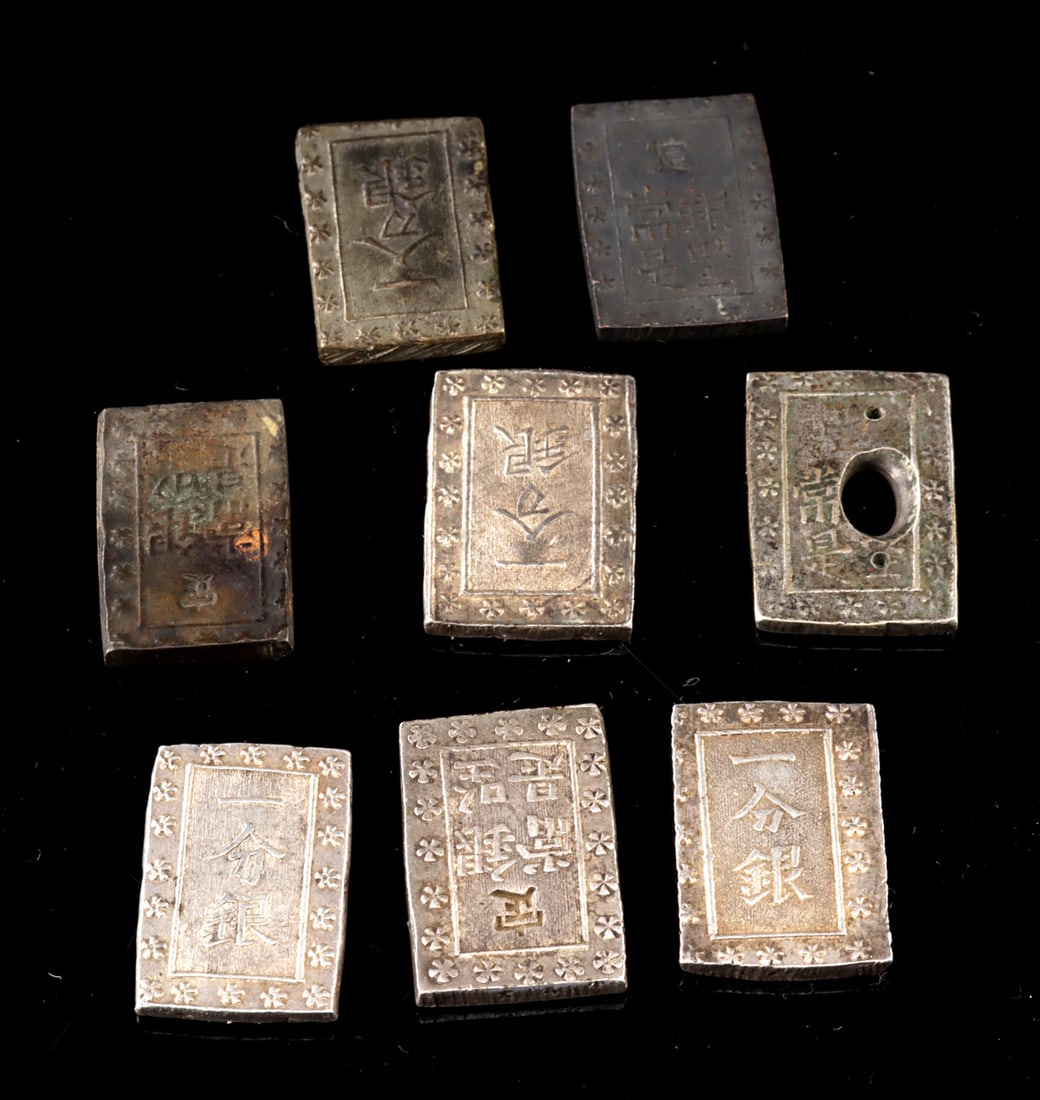Four Japanese Edo Era Ichibugin Silver Coins: East Asia, Japan, late Edo period, ca. mid-19th century CE. A group of rectangular Ansei Ichibugin coins in the traditional late Tokugawa format, each struck with inscriptions and decorative borders -