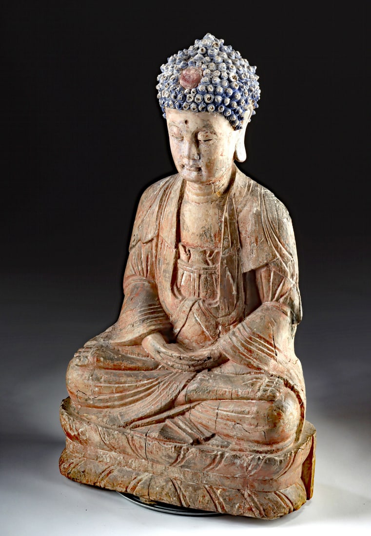 Large Chinese Ming Dynasty Polychrome Wood Buddha: East Asia, China, Ming Dynasty, ca. 1368 to 1644 CE. A large wooden Buddha statue, sculpted with plaster or stucco, featuring tightly coiled curls. The figure is seated on a lotus pedestal in the dhya
