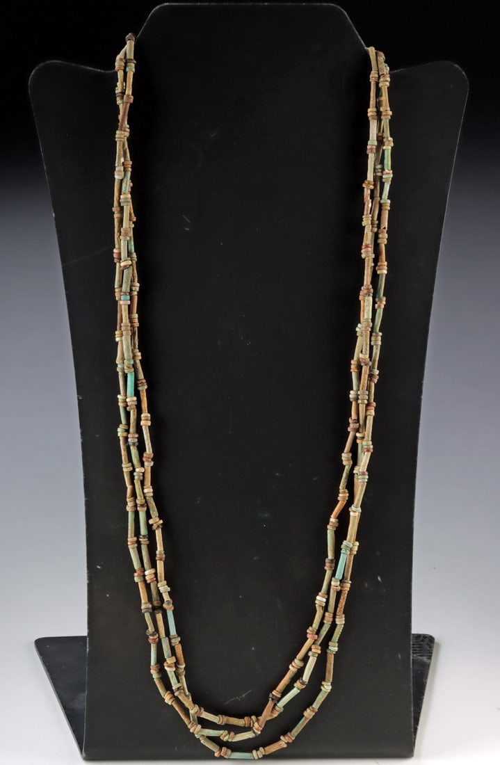 Wearable Egyptian Faience Bead Multistrand Necklace: Ancient Egypt, New Kingdom to Late Dynastic periods, ca. 1500 to 300 BCE. A necklace composed of ancient faience beads in shades of muted green, tan, brown, and blue, including elongated tube beads
