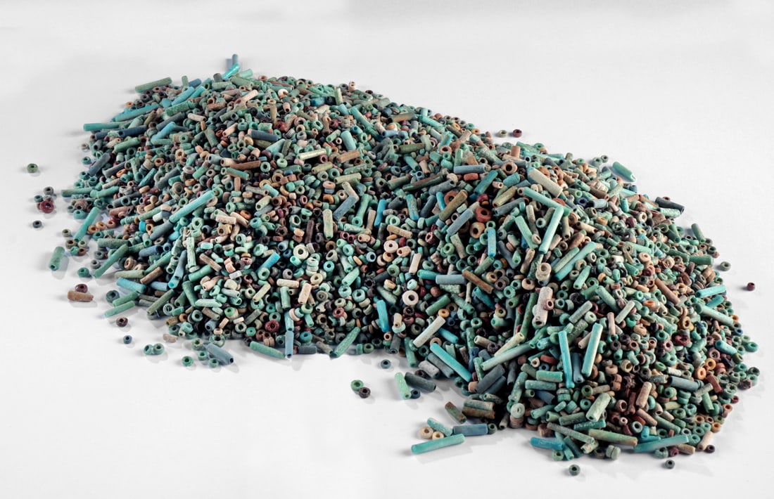 Hundreds of Loose Egyptian Faience Beads for Jewelry: Ancient Egypt, New Kingdom to Late Dynastic periods, ca. 1500 to 300 BCE. A large assortment of loose faience beads in shades of blue, brown, blue, tan, and black. The group includes numerous small sp