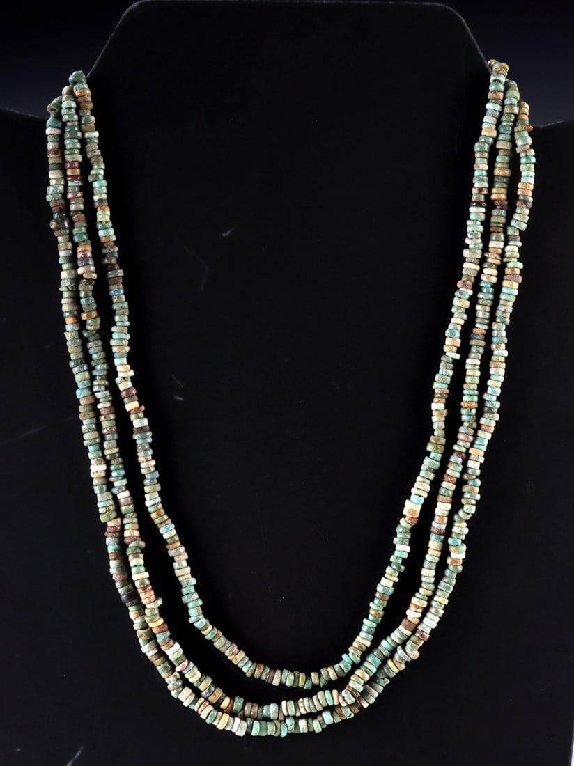 Three Ancient Egyptian Faience Bead Necklaces: Egypt, New Kingdom to Late Period, ca. 1550 to 332 BCE. A group of three single-strand necklaces composed of ancient faience disk beads in soft turquoise, pale blue, and earthy tones characteristic of