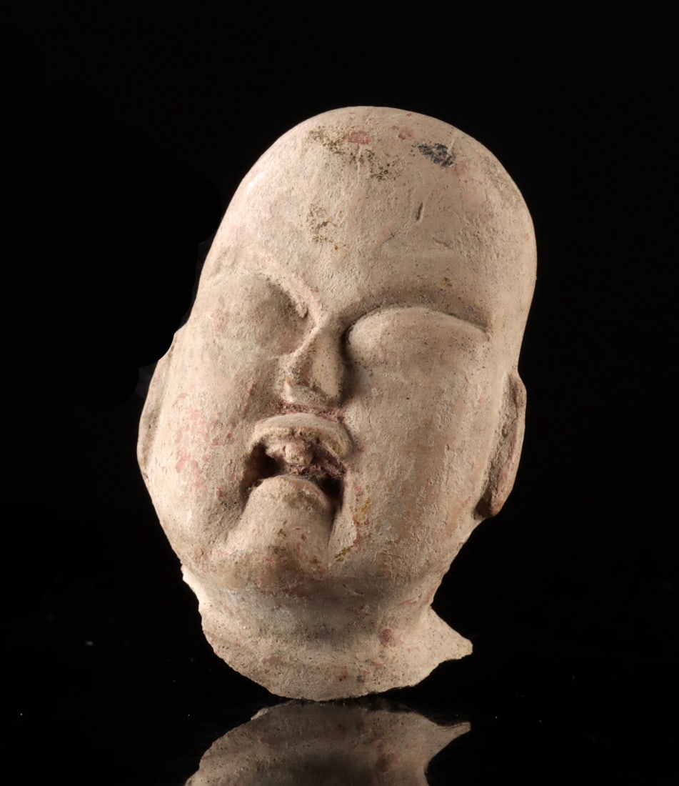 Miniature Olmec Pottery Baby Head: Pre-Columbian, Mesoamerica, Olmec culture, ca. 1200 to 400 BCE. A finely modeled miniature pottery head depicting an Olmec infant, characterized by the culture's distinctive facial features including