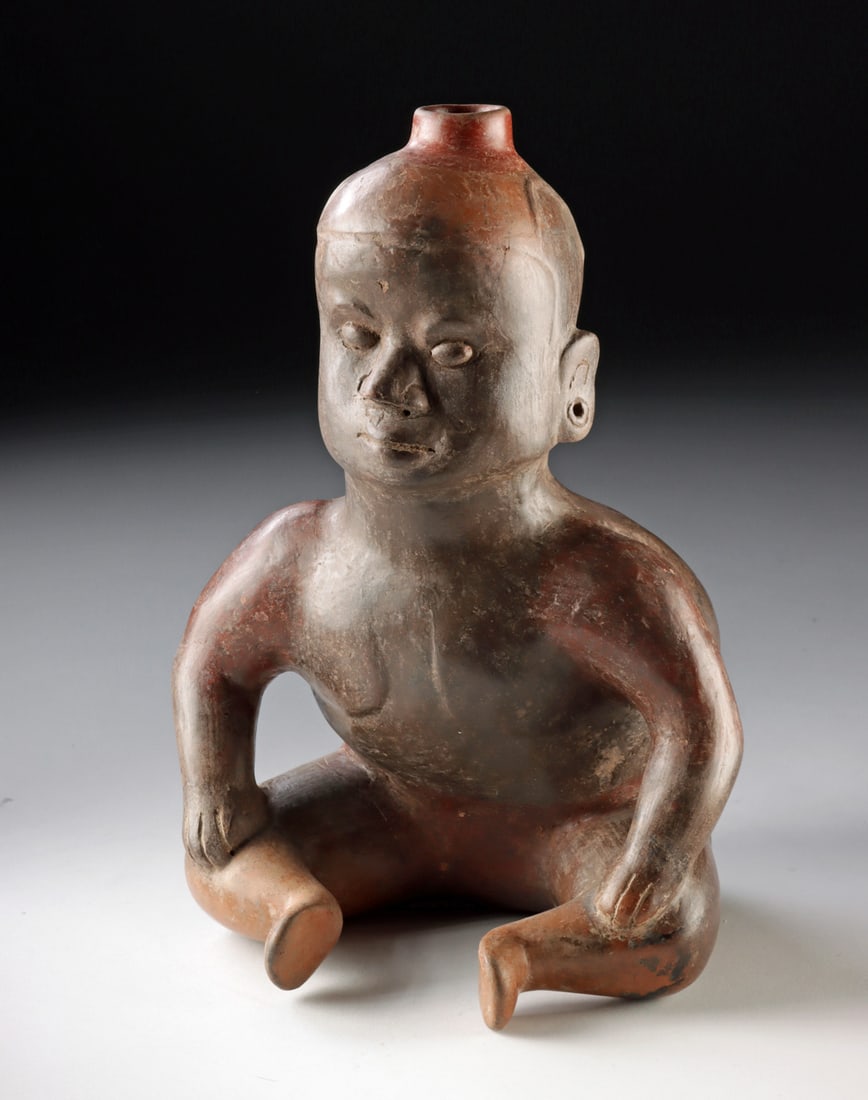 Colima Pottery Hunchback Dwarf Figural Vessel: Pre-Columbian, West Mexico, Colima culture, ca. 300 BCE to 300 CE. A wonderfully expressive seated figure forms this striking Colima figural vessel, its rounded head rising into a small cylindrical sp