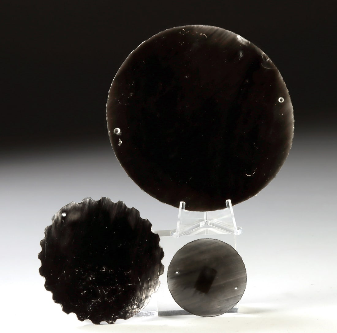 Aztec Obsidian Mirrors - Set of Three: Pre-Columbian, Central Mexico, Aztec culture, ca. 14th to early 16th century CE. A striking group of three Aztec mirrors crafted from highly polished black obsidian, a volcanic glass prized in Mesoame