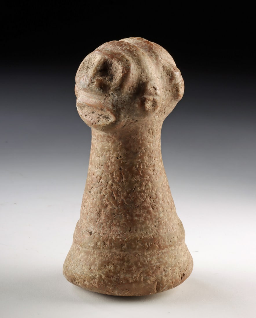 Taino Janiform Stone Zemi Ritual Pounder: Pre-Columbian, Caribbean, Taino culture, ca. 1200 to 1500 CE. A striking Taino stone ceremonial pounder crowned with a janiform handle carved as two opposing zemi heads, their rounded eyes and simplif