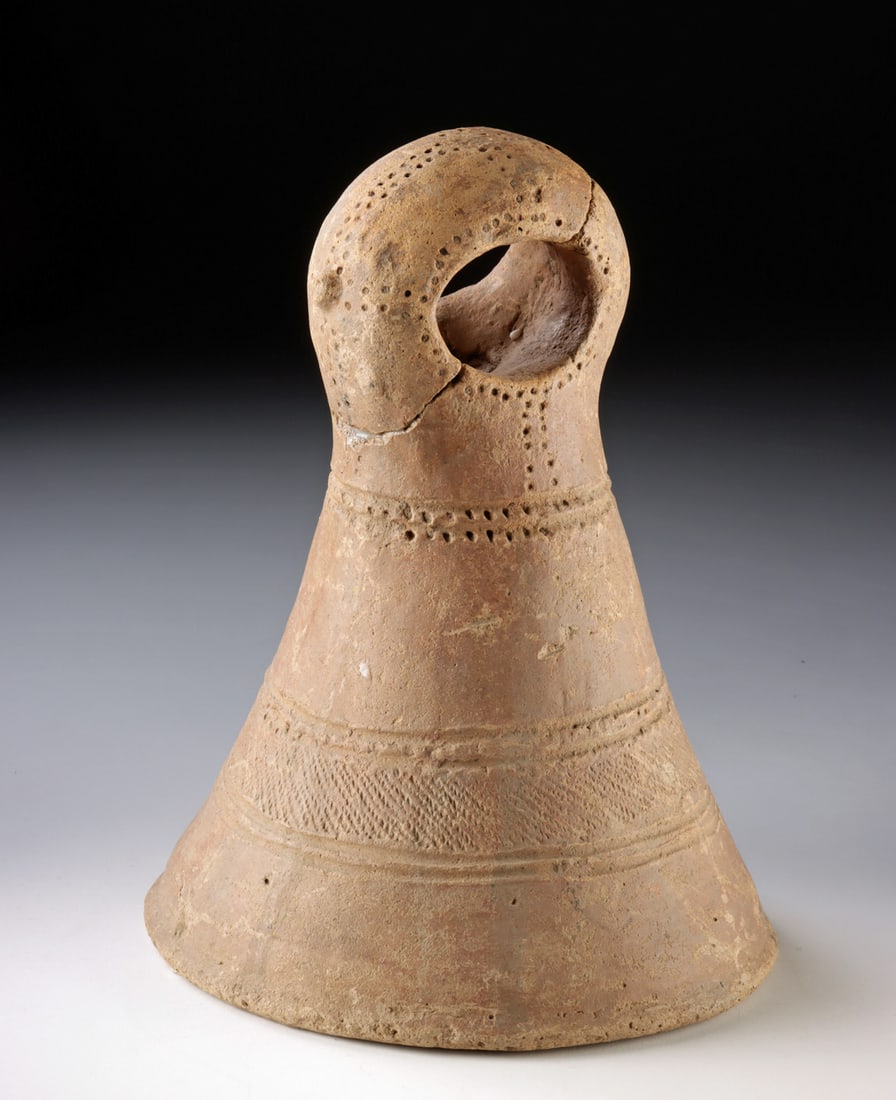 Large African Mali Pottery Bedframe Support Post: Western Africa, Mali, Djenne, ca. 19th to early-20th century CE. A sturdy terracotta conical support post featuring a thick ring-shaped loop at the top used to receive wooden beams forming the