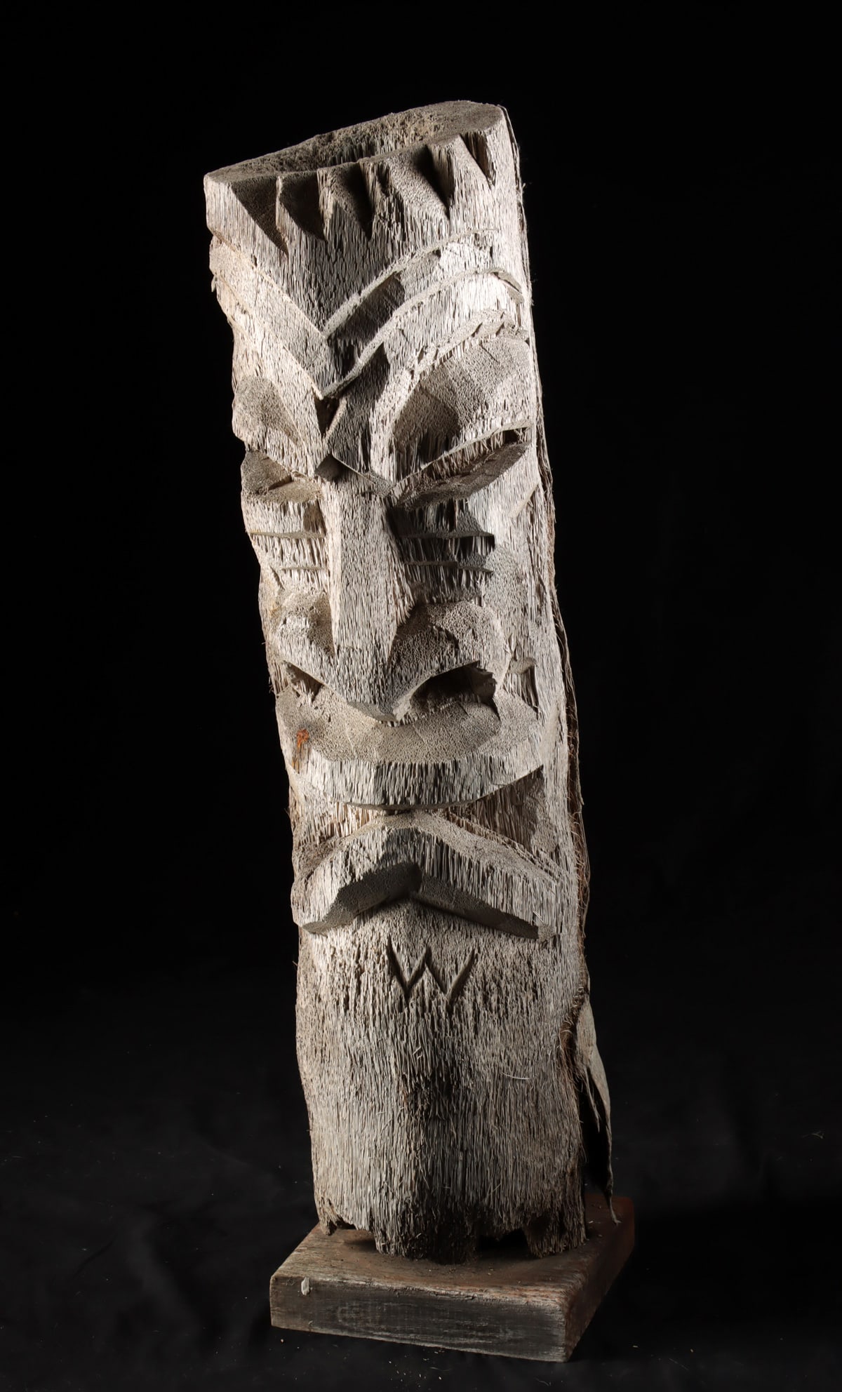 Hawaiian Carved Wood Tiki Statue: North Pacific, Polynesia, Hawaii, ca. mid to late 20th century CE. A tall carved wooden tiki figure displaying the bold geometric features characteristic of Hawaiian-inspired folk carvings produced fo