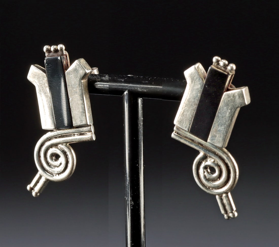 Pair of Sucesores de Spratling Silver & Onyx Earrings: William Spratling (American/expatriate in Mexico, 1900-1967). Produced by Sucesores de William Spratling. Pair of silver and onyx earrings, ca. 1979 or later. Both have Spratling and "TS-24" marks on