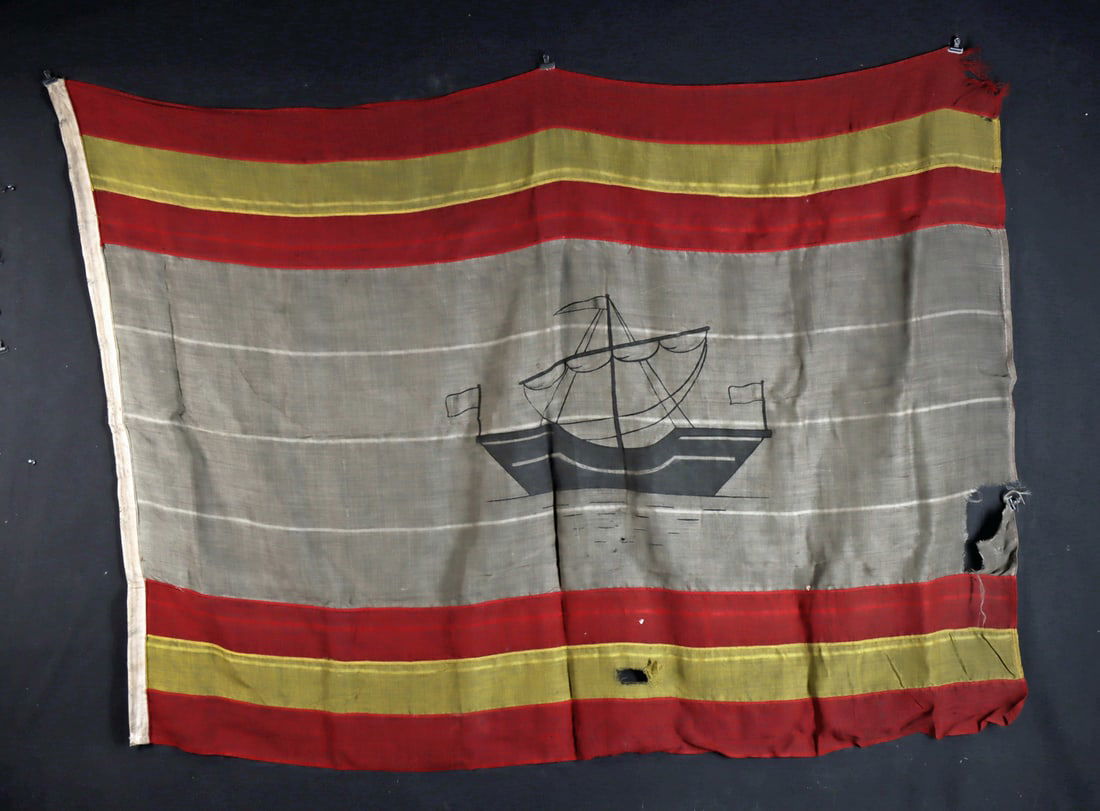 WWII Era Spanish Merchant Ship Ensign Textile Flag: Western Europe, ca. 1939 CE. A loosely woven cotton or burlap textile flag made in the style of a Spanish merchant marine ensign, constructed from separate red, white, and yellow sections and featurin