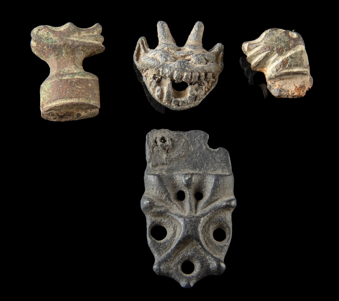3 Early Modern Gargoyle Heads + Medieval Strap End: Europe, Early Medieval to Post-Medieval periods, ca. 9th to 17th century CE. A group of four metal artifacts including three miniature gargoyle or grotesque heads dating to the 17th century and one Ea